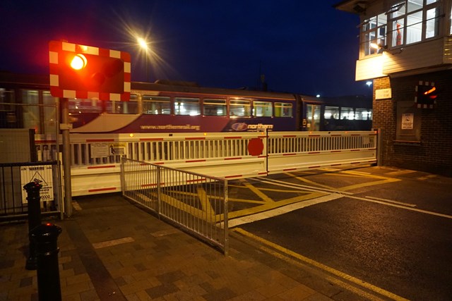 The first train passes new level crossing barriers at West Dyke Road, Redcar