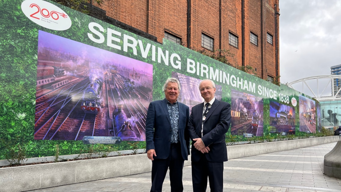 Railway scenes by famous artist on display at Birmingham New Street: John Austin and Fraser Pithie in front of artwork