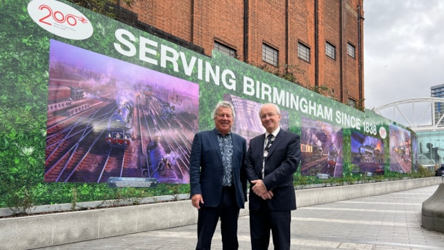 Railway scenes by famous artist on display at Birmingham New Street: John Austin and Fraser Pithie in front of artwork