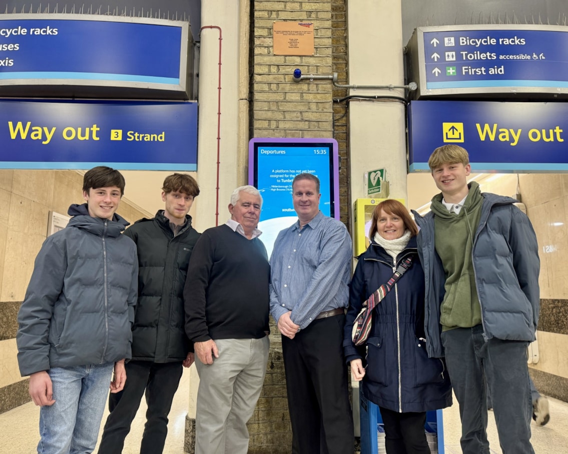 The Jones family in front of the plaque
