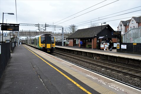 Customer buys coffee at Small Talk Saves Live coffee cart at Tile Hill station