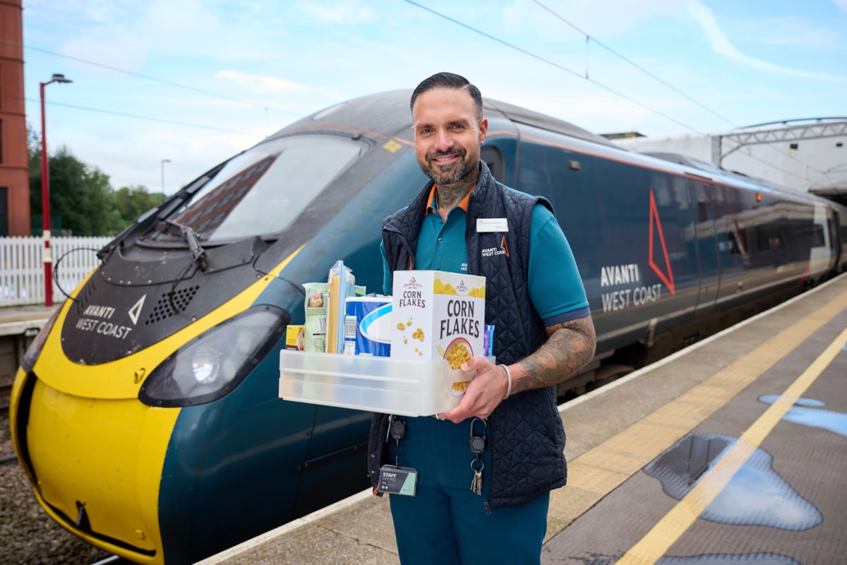 Zeb Nash, who volunteers as an Avanti West Coast Community Champion, with a collection box for donations made to Stoke-on-Trent Foodbank