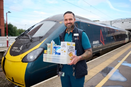 Zeb Nash, who volunteers as an Avanti West Coast Community Champion, with a collection box for donations made to Stoke-on-Trent Foodbank