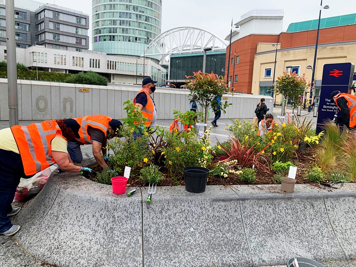 Volunteers working on Birmingham New Street's flower planters June 2021