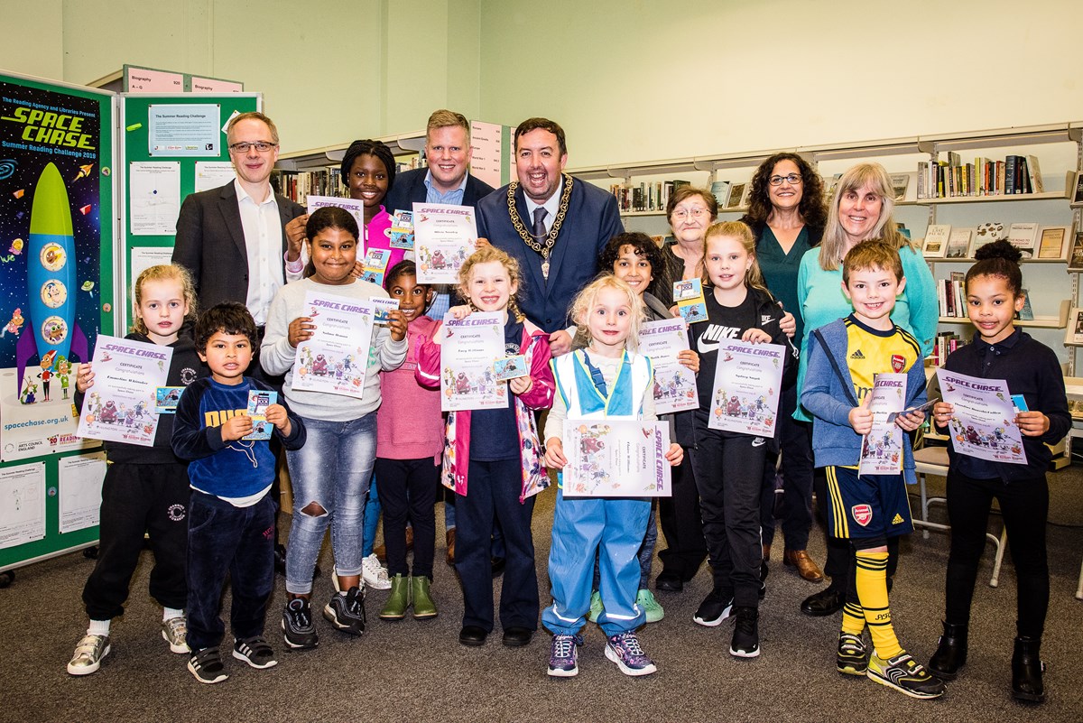 Children celebrate the completion of the 2019 Summer Reading Challenge, with Islington Councillors Richard Watts, Diarmaid Ward, Troy Gallagher, Marian Spall, Asima Shaikh and Tricia Clarke.