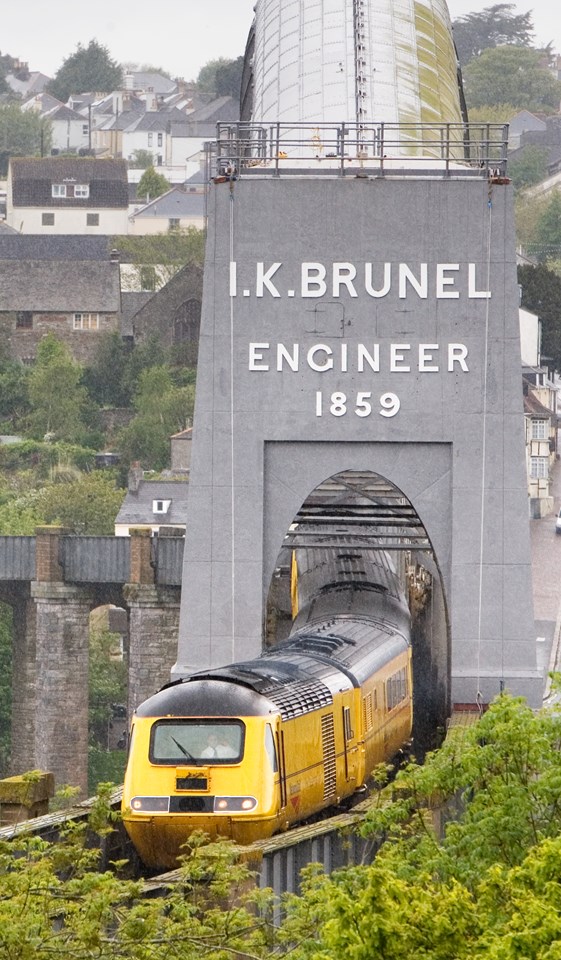 Royal Albert Bridge - unveiling Brunel's name: Portrait shot of Isambard Brunel's Royal Albert Bridge with Network Rail New Measurement Train passing through it.