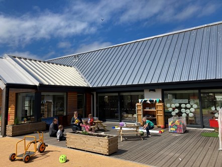 Children playing outdoors at Pilmuir Nursery