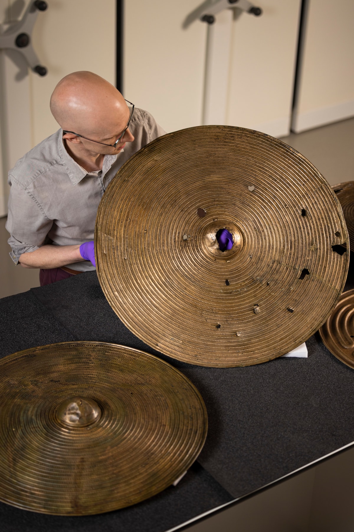 National Museums Scotland curator Dr Matthew Knight with the Bronze Age shields. Photo © Duncan McGlynn (3)