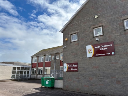 Exterior view of Keith Grammar building on a bright day.