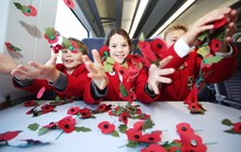 Pupils from Dover College Junior School learn the inspiration behind the poppy as a symbol of remembrance on board Southeastern's High Speed Poppy Train v2