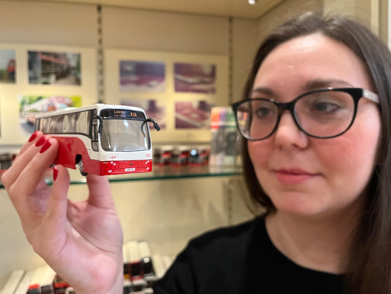 Bus collection: Assistant community curator Sapphia Cunningham-Tate alongside the new display at Leeds City Museum which gives visitors a chance to see a selection of the vast array of replicas created by physicist Dr Gordon Brooke.
The meticulously detailed models each relate to a specific real-life equivalent, complete with service number and with every painstaking detail reproduced using card, packaging and acetate for the windows.