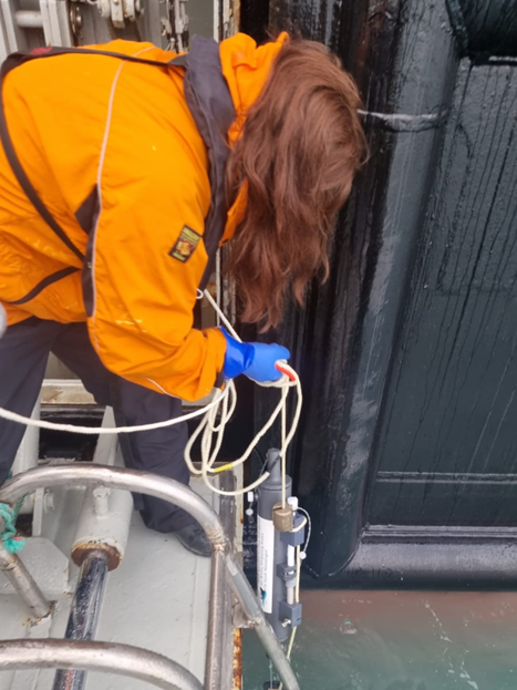 Elizabeth Boyse collecting seawater samples in the Northwest Passage