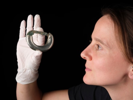 Conservator Bethan Bryan holds a bronze fitting. Photo © National Museums Scotland (1)