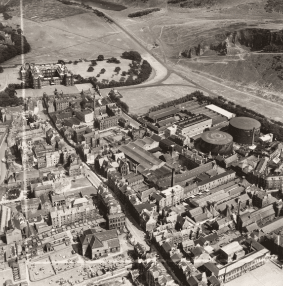 Aerial view of the Canongate area c. 1951 including Holyrood Palace, the Meadow Flat Gas Holders (now the site of Dynamic Earth) and Holyrood Brewery (now the site of the Scottish Parliament).