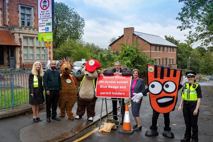 School Streets Blenheim Primary School September 2023: L-R Mo Duffy, Headteacher of Blenheim Primary School, Councillor Javaid Akhtar, mascot Spike, mascot Kerby, Gary Bartlett, Head of Highways and Transportation at Leeds City Council, Leeds City Council’s executive member for sustainable development and infrastructure, Councillor Helen Hayden, mascot Strider and PCSO Becca Bowles.