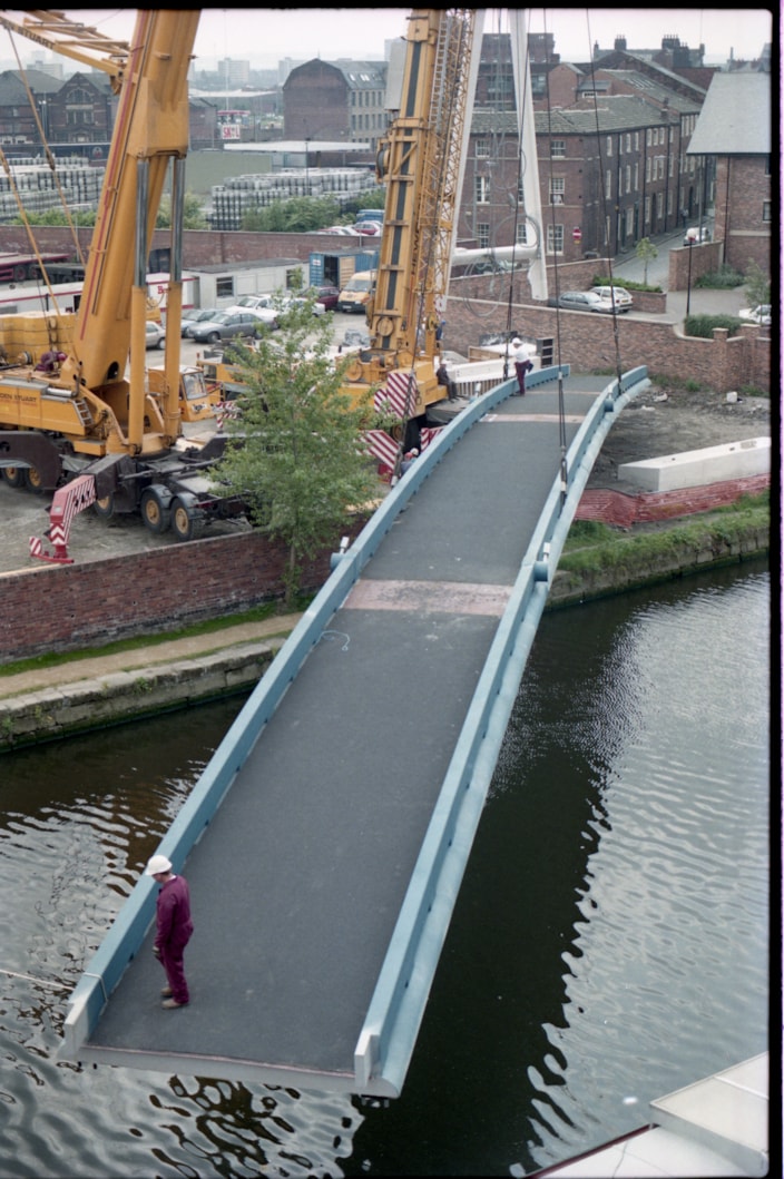 Centenary Bridge: Originally constructed in 1993, at that time the bridge was the first river crossing built in the city for more than a century, and its distinctive sweeping design has since become a much-loved riverside feature. Picture shows the bridge being winched into place during construction. Credit Yorkshire Design Group.