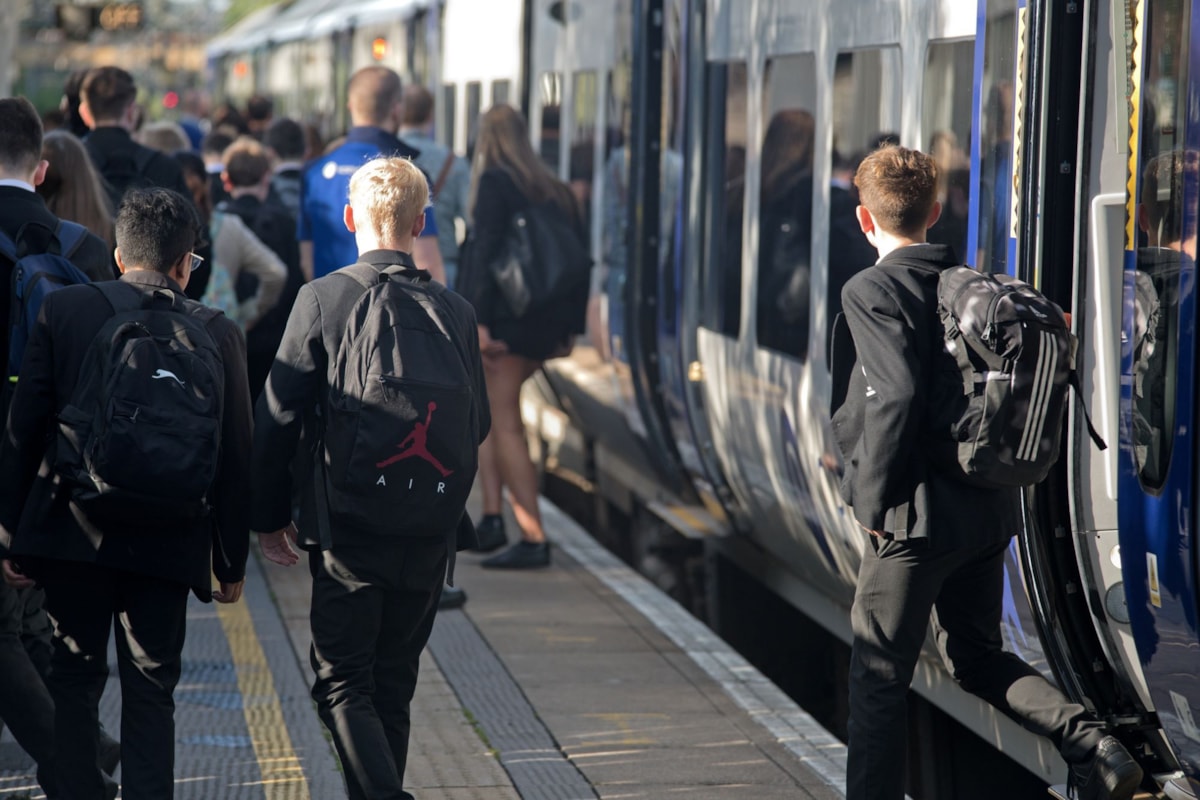 Image shows secondary school students commuting to school