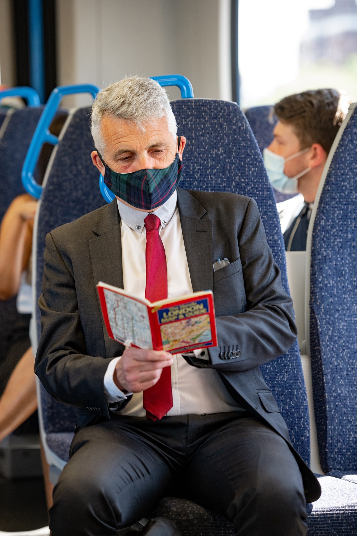 Businessman travelling to London by train (Vertical)