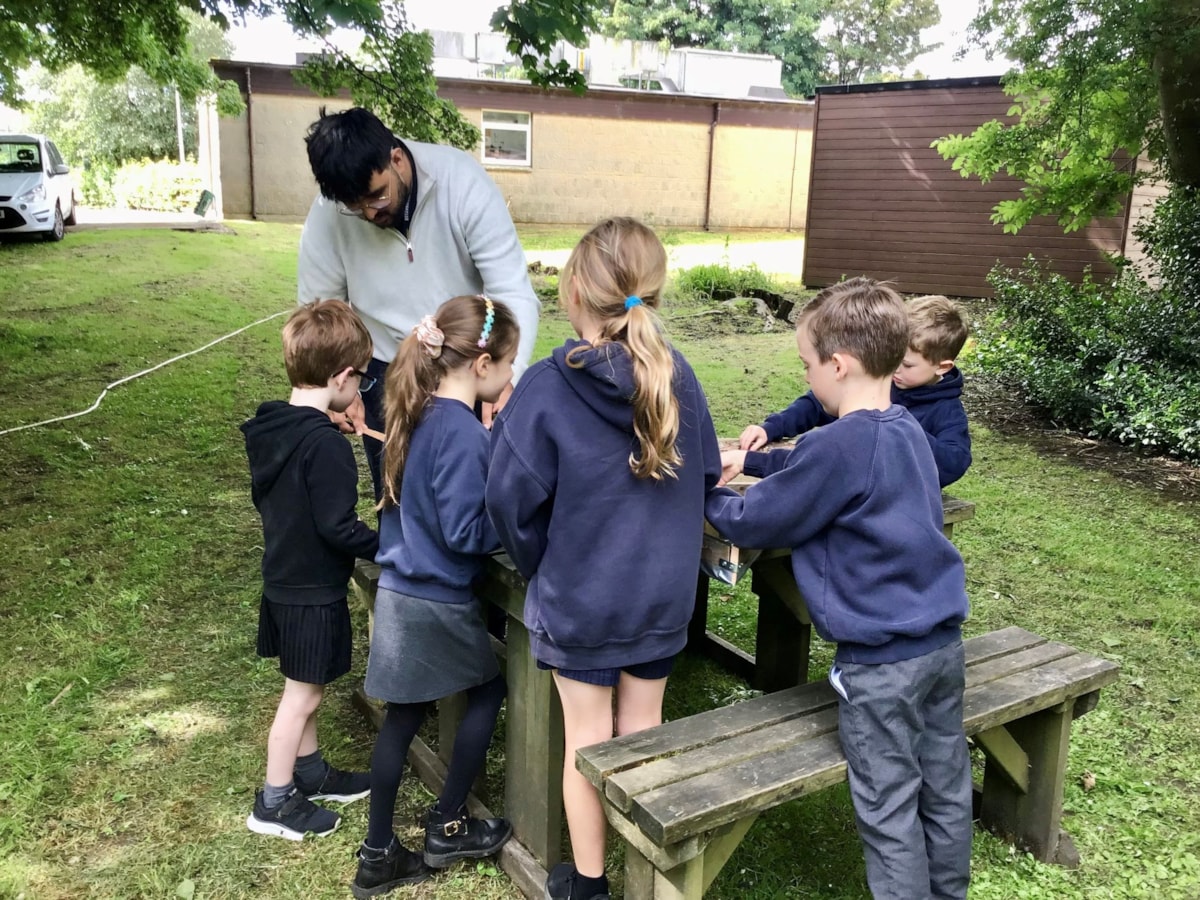 Image shows students helping to create bug hotel for Gargrave station