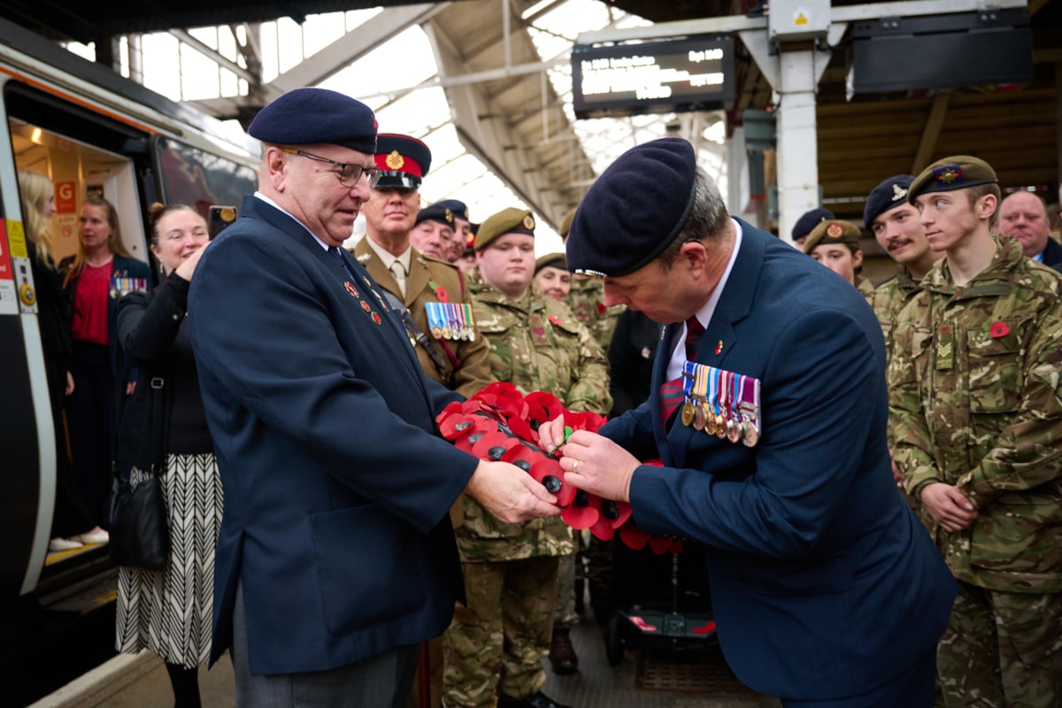Lot R: Steve Brammer of the RBL and Avanti West Coast's Andrew Walker at Crewe Station with the wreath that travelled to London Euston.