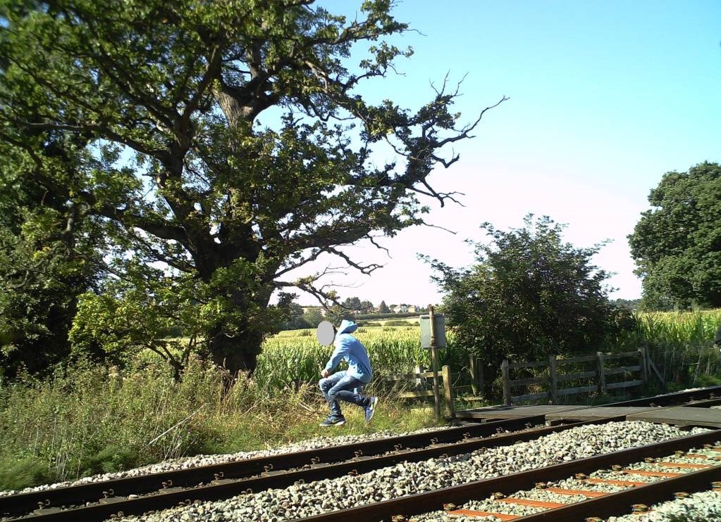 A boy jumps along the track near Wrexham