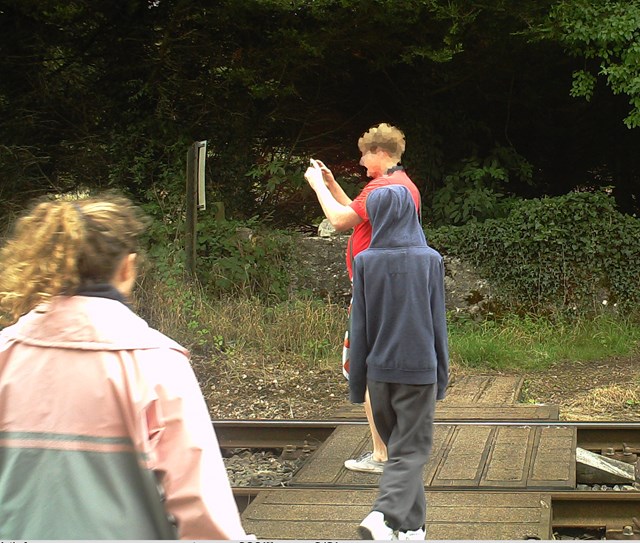 Phone Smart - gentlemen looking down the track and taking a picture