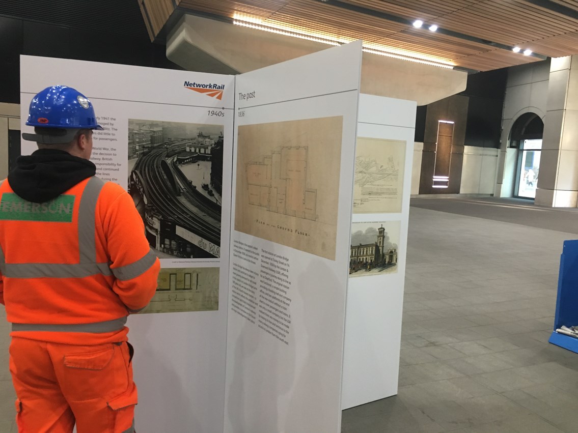 Construction worker LB: A construction worker reads about the history of London Bridge station