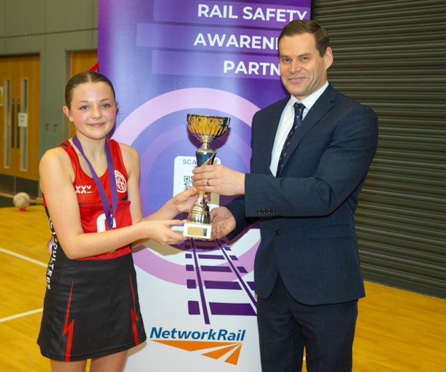 21040759: GLASGOW, SCOTLAND - APRIL 19: Ross Moran presents the winner's trophy as Network Rail announce a three-year partnership with Netball Scotland at the Emirates Arena, on April 19, 2024, in Glasgow, Scotland.