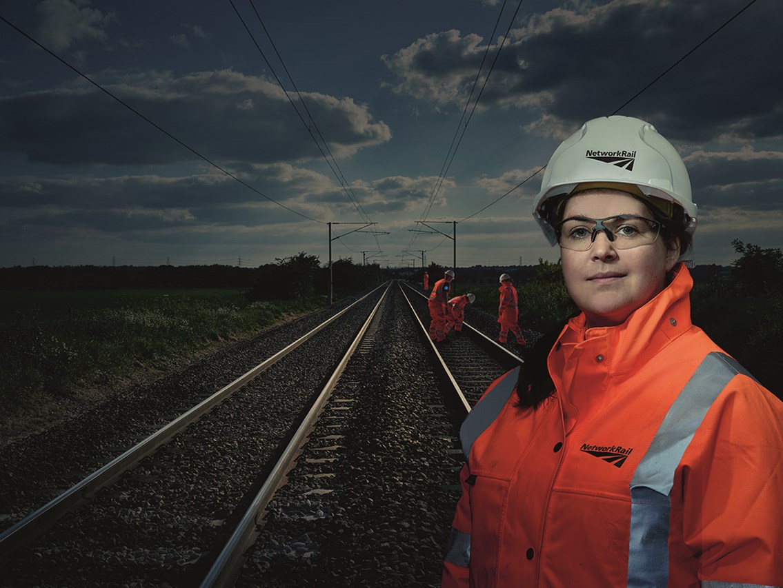 Rebecca Grogan, mobile operations manager: Rebecca Grogan, one of our Orange Army female/woman mobile operations manager (MOM)

Engineers can be seen on track in the background

Rebecca is working over Easter bank holiday on our Railway Upgrade Plan