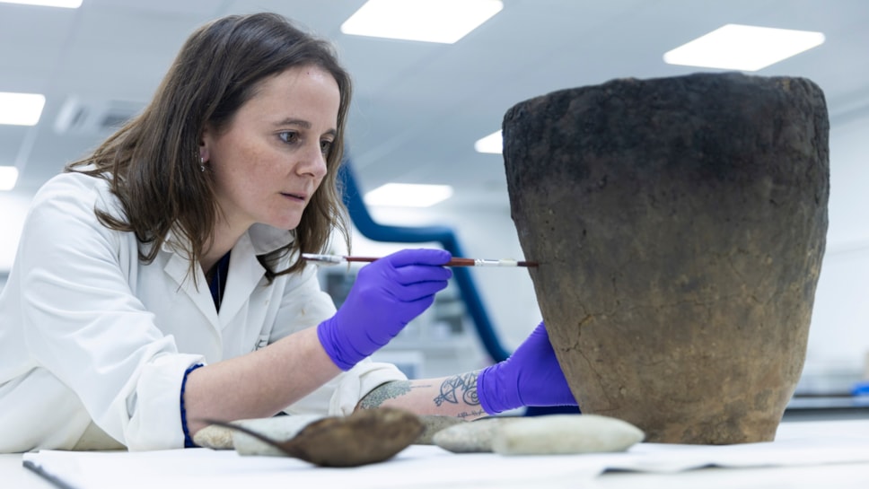 National Museums Scotland conservator Bethan Bryan works on the Bronze Age Achmore Vessel, 1000 - 500 BC. Image © Duncan McGlynn