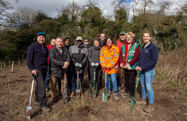 Tree Sustainability: Team from Network Rail planting trees at Alton with NR Head of Environment Sarah Borien in orange, Sara Lom, CEO Tree Council to the right of her, and Sophie Reigate of Naturetrek