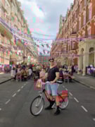 Christine’s photograph of her partner Jeff on a Santander Cycle on the Coronation Day of His Royal Highness King Charles III as they spontaneously stumbled upon a street p: Christine’s photograph of her partner Jeff on a Santander Cycle on the Coronation Day of His Royal Highness King Charles III as they spontaneously stumbled upon a street p