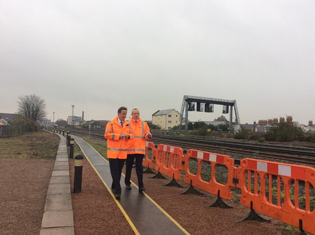 The Prime Minister David Cameron joins Mark Langman, route managing director for Network Rail Wales, to look at the railway tracks outside the Wales rail operating centre in Cardiff: The Prime Minister David Cameron joins Mark Langman, route managing director for Network Rail Wales, to look at the railway tracks outside the Wales rail operating centre in Cardiff