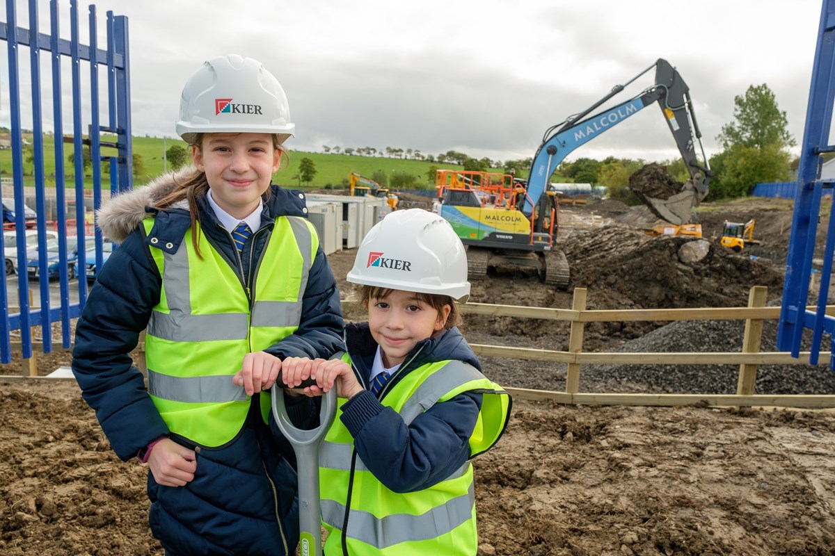 Evie P5 and Lucy P2 help to officially break the ground at their new school