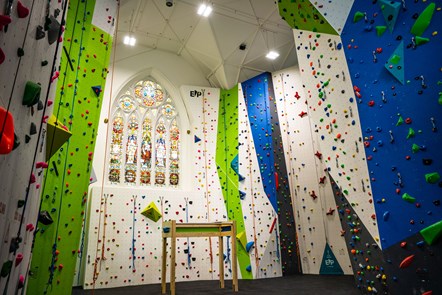 indoor climbing centre set in former church with stained class feature