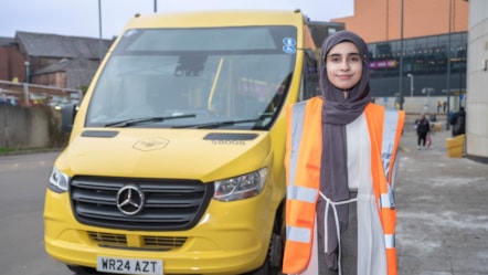 Amana T level student with Bee Network bus at Rochdale depot