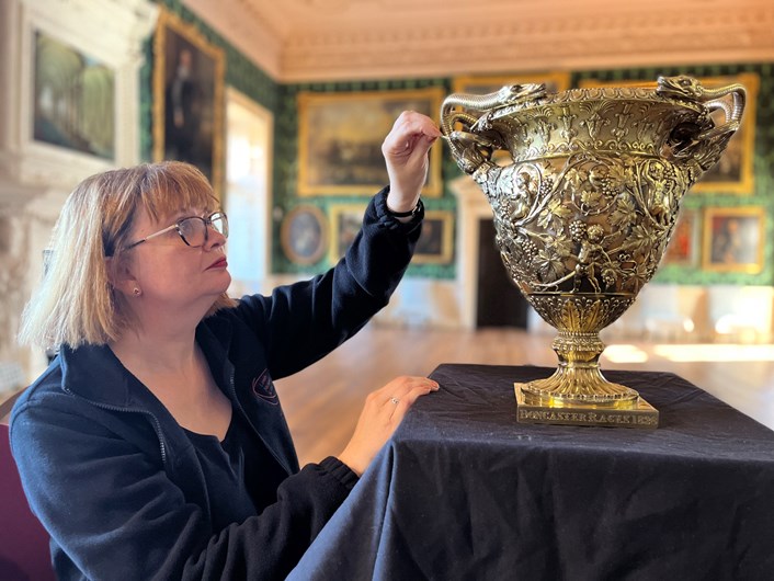 Temple Newsam treasures: Leeds Museums and Galleries conservator Emma Bowron with the silver gilt Doncaster Gold Cup 1828-29, part of an array of silverware that has been conserved for a revamped display at Temple Newsam House.