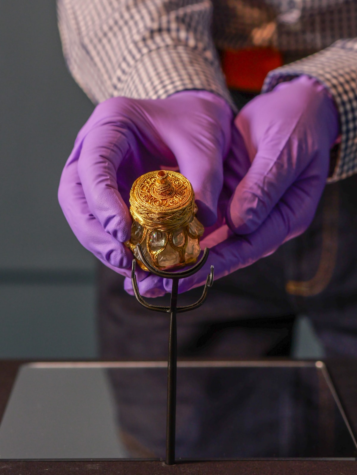 National Museums Scotland curator Craig Angus puts finishing touches to the installation of the Rock Crystal Jar from the Galloway Hoard at Kirkcudbright Galleries, image credit Andy Jardine-2