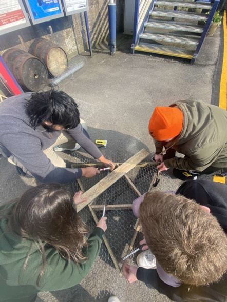 Image shows Year in Industry students creating'Bug Hotels' - 5