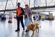 TfL Image - A staff member helps a blind customer at Stratford station: TfL Image - A staff member helps a blind customer at Stratford station