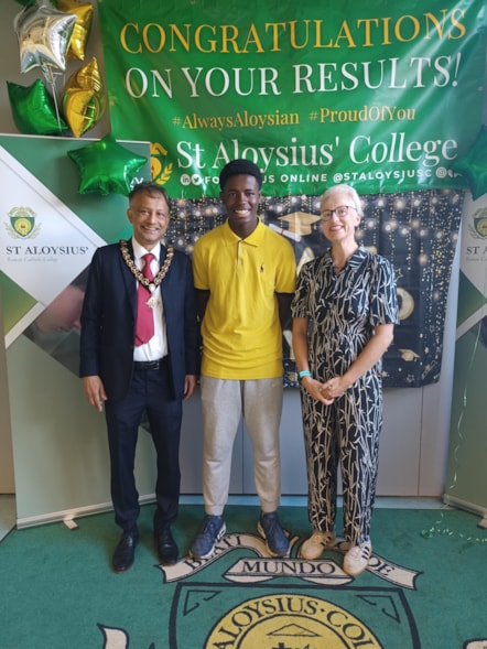 St Aloysius' RC College student Chrishna celebrates his GCSE results with Deputy Mayor Cllr Jilani Chowdhury, left, and Cllr Sheila Chapman, Executive Member for Children, Young People and Families, right.