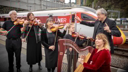Linlithgow String Orchestra besides an LNER Azuma at Edinburgh Waverley station.