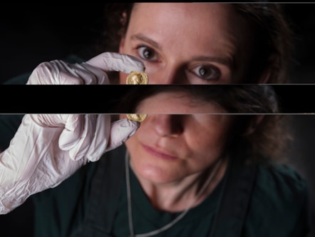 Conservator Bethan Bryan examines the gold Aureus of Trajan. Image © National Museums Scotland (1)