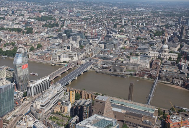aerial- Blackfriars (1): London Blackfriars station, featuring the longest solar bridge in Europe. The Tate Modern is bottom right , St Paul's middle right. St Pancras and King's Cross are in the distance (top left)