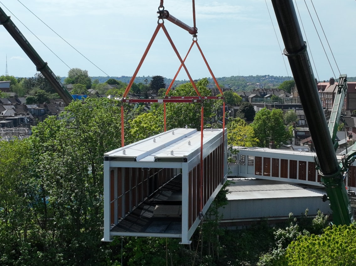 Cross section of footbridge being lifted into place at Hither Green