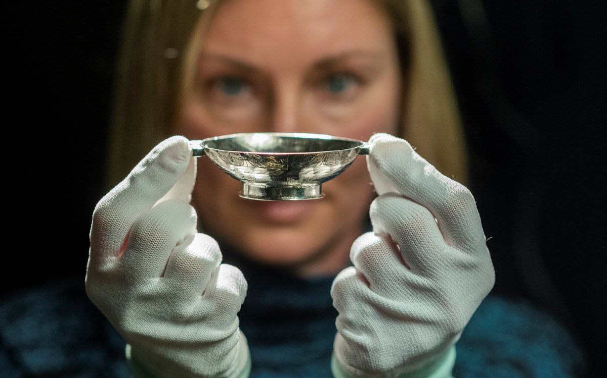 Lyndsay McGill, Curator of Renaissance and Early Modern History at National Museums Scotland, holds the 17th century silver quaich. Photo © Phil Wilkinson