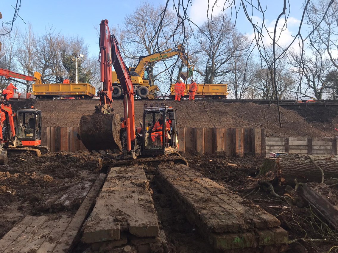 Network Rail reopens Dorking-Horsham railway after 30 metre landslip: Piled wall Ockley awaiting backfilling