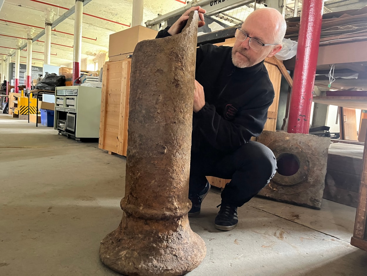 Train station excavation: John McGoldrick, Leeds Museums and Galleries’ curator of industrial history with the remnants of one of the station’s huge cast iron pillars, which would once have held up the roof while passengers made their way around its platforms. The impressive iron columns also doubled as rainwater down pipes.