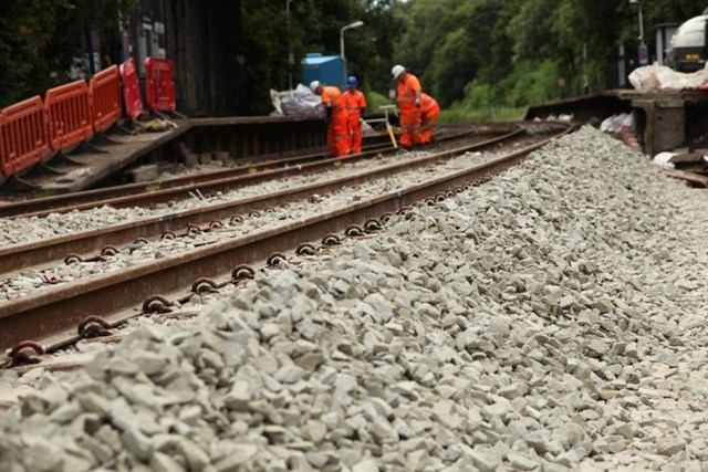 Railway line between Manchester and Buxton opens after landslip: Orange army completing the work at Middlewood