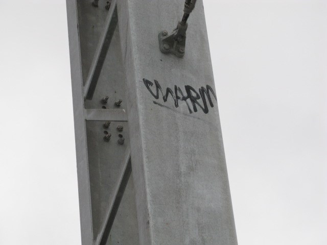 Graffiti inches from the 25,000 volt power lines
